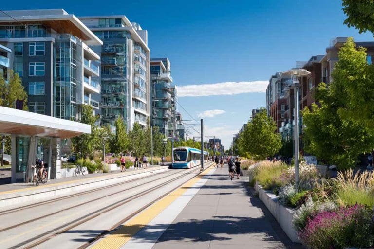 A_modern_Calgary_urban_neighborhood_with_a_visible_ctrain